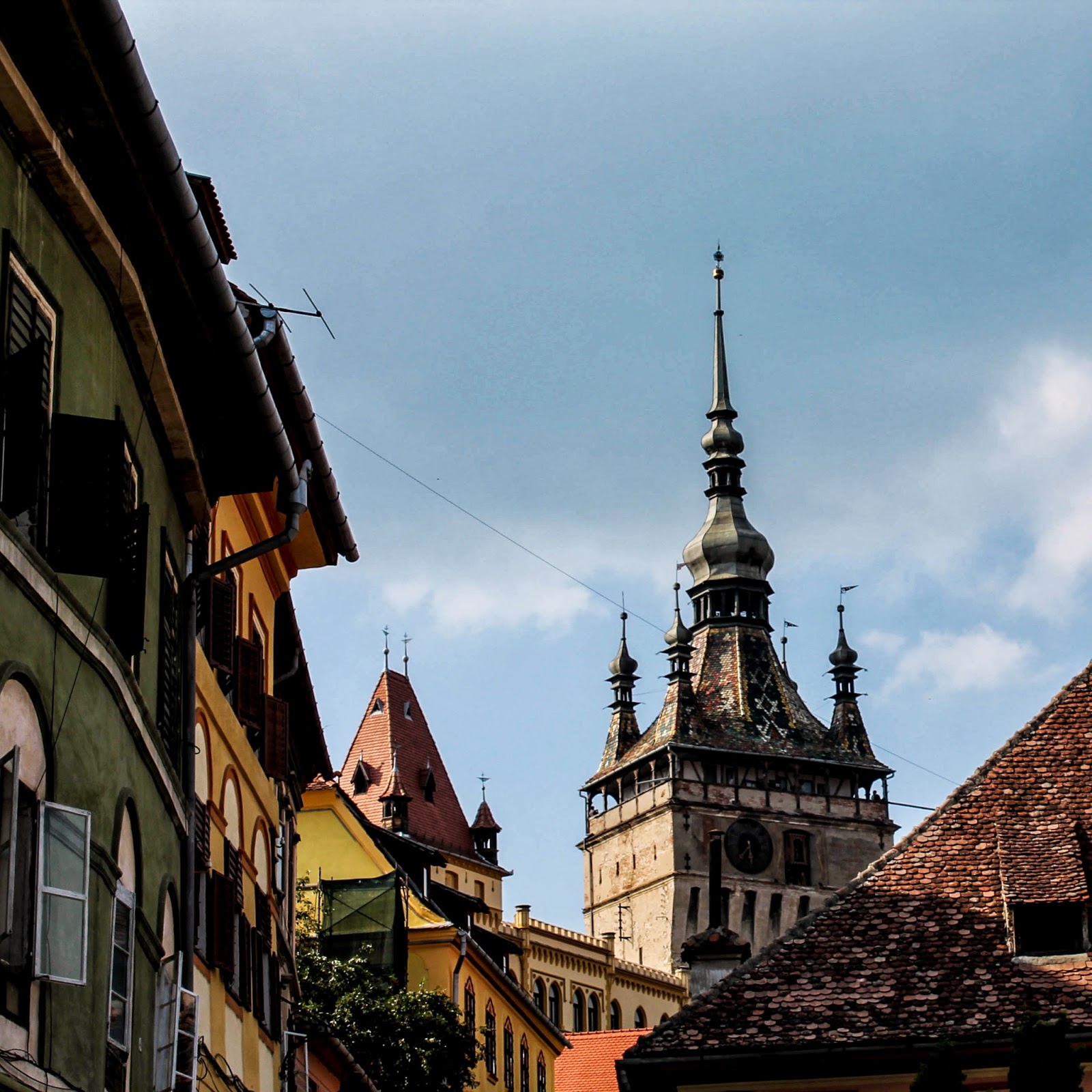 Det färgglada klocktornet i Sighișoara höjer sig över historiska gränder och hus.